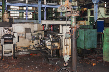 An abandoned old large industrial hall is waiting for demolition, an Industrial machine for metal processing, A former Khabarovsk plant for the production of a diesel engine.