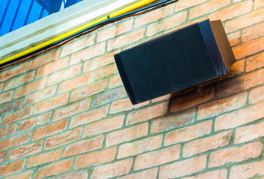 Old-fashioned Speakers Mounted On A Brick Wall In A Restaurant To Play Music For Diners. Real Speaker Images That Are Always In Use.