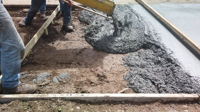 Cement pours and spreading from cement trough