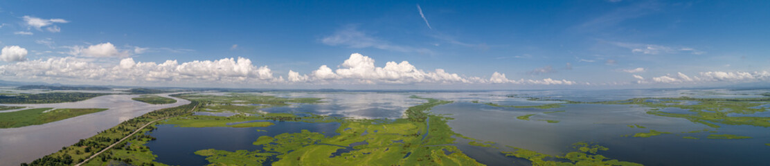Aerial view panorama of Magdalena River landscape, Colombia with blue sky and white clouds on a sunny day