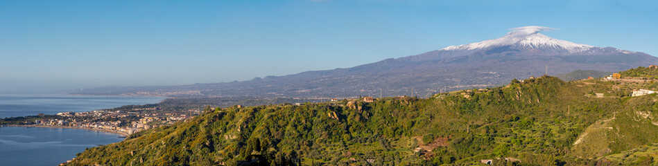 Fototapeta na wymiar Taormina - The Mt. Etna volcano over the Sicilian coastal landscape.