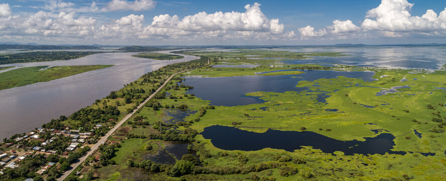 Panoramic aerial view of impressive Magdalena River landscape with blue sky, white clouds and village on a sunny day