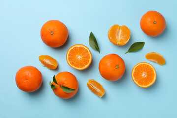 Ripe sweet mandarins on blue background, top view