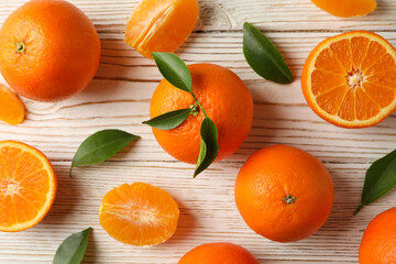 Ripe sweet mandarins on white wooden background, top view