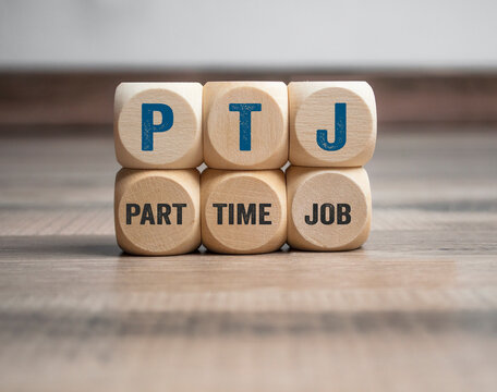 Cubes or dice with acronym PTJ for Part Time Job on wooden background