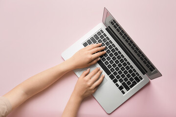 Fototapeta na wymiar Female hands with modern laptop on color background