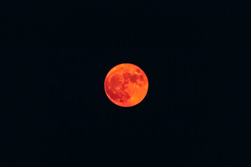 Thick orange haze over blurry orange full moon, reduced visibility from smoke and blazing record wildfires, San Francisco California, United States. Image is not blurry it illustrates poor air quality © SvetlanaSF