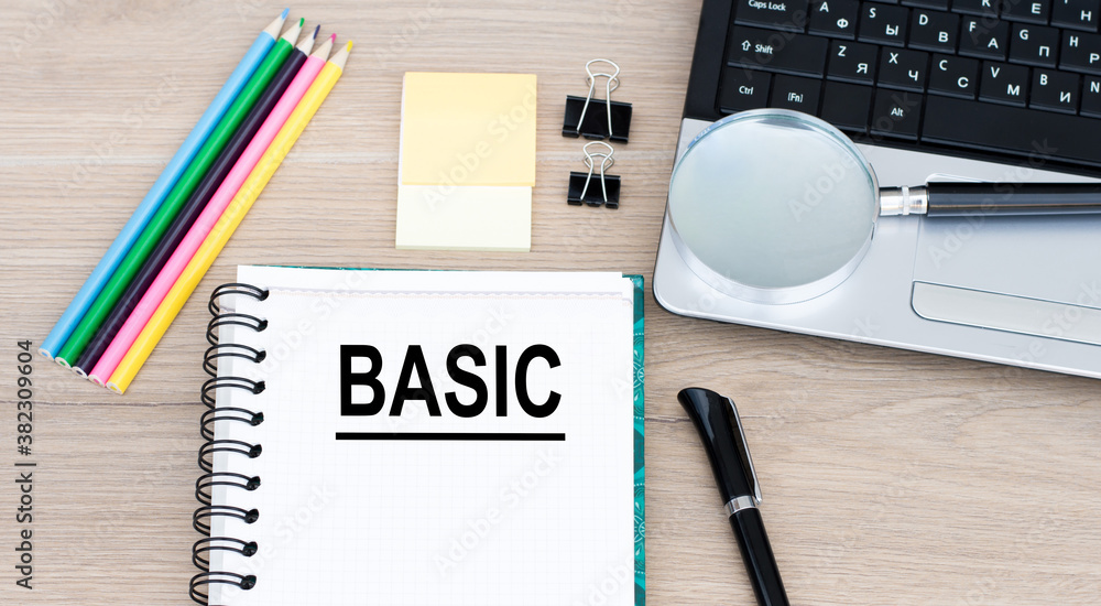 Poster laptop, pen and notepad with text basic in the white background with office tools