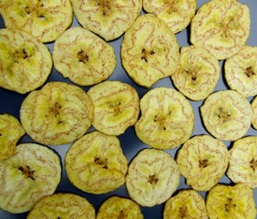 Plantain or green banana chips on ceramic plate.