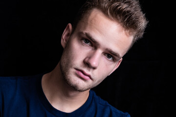 Fototapeta premium Portrait of a serious, pensive young unshaven guy
