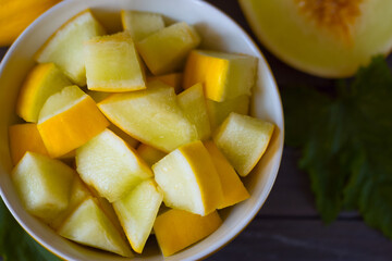 sliced ripe melon in a bowl top view. melon slices in a bowl close-up.