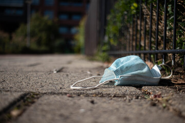 Corona face mask tossed away on the streets in a Dutch suburban area