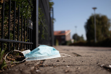 Corona face mask tossed away on the streets in a Dutch suburban area