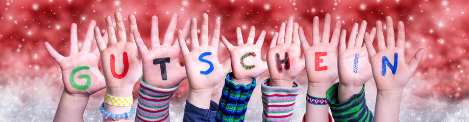 Children Hands Building Colorful German Word Gutschein Means Voucher. Red Snowy Christmas Winter...