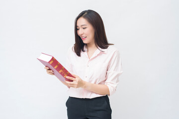 Fototapeta premium portrait of beautiful woman student in pink shirt is holding a book isolated over white background studio