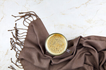Cup of coffee and plaid on light background. Autumn composition. Flat lay, top view