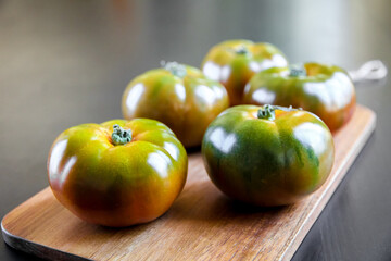 Black Krim organic tomatoes on a cutting board