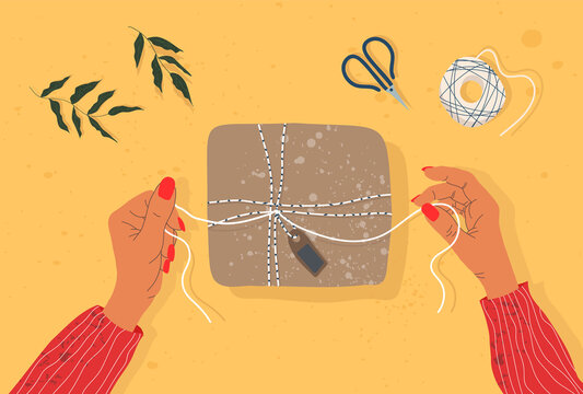 Hands and gift box on the table. Trendy illustration of hands, gift box, scissors and tree branch. On the table, top-down view. Hand-drawn modern illustration for web and print.