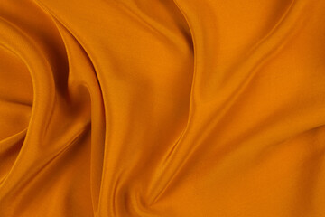 Golden silk or satin luxury fabric texture can use as abstract background.