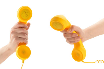 Yellow handset in woman hand isolated on white.