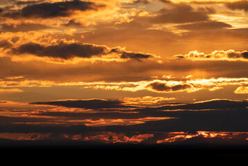 Obraz premium a close up view of golden clouds on the horizon during sunset in Marbella, Spain 