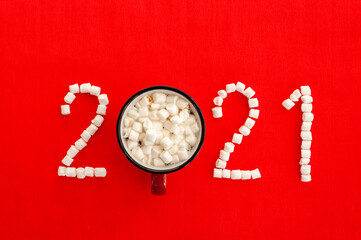 New Year's coffee 2021. A mug of coffee or cocoa and a figure 2021 composed of marshmallows and...