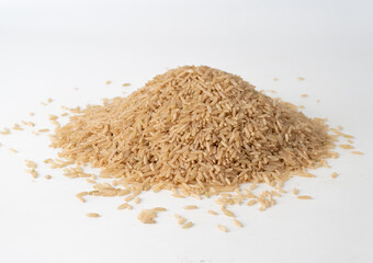 Pile of brown rice on a white background