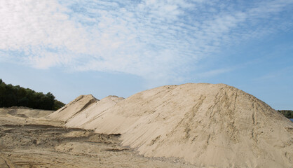 a pile of yellow river sand on the river Bank.