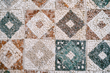 Ceramic mosaic in the form of squares with rhombuses of different colors.