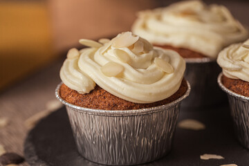 Pumpknin cupcake with white cream and almonds