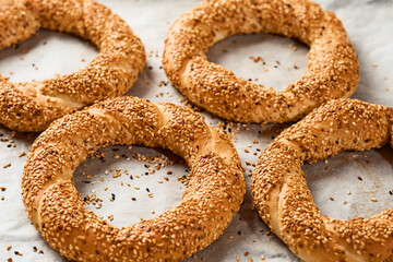 Freshly baked simit on a baking sheet - a close-up sesame bun (Turkish bagel - Gevrek or Kuluri)....