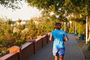 Obraz premium A young man running in the park in the morning.