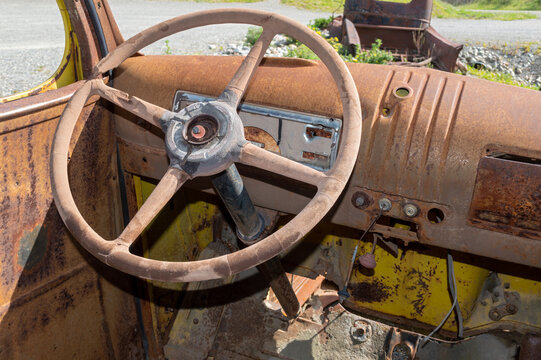 Rusty interior and steering wheel of an antique truck
