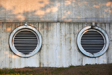 Large ventilation circles on an old wall.