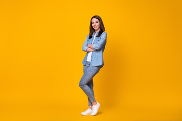 Fototapeta na wymiar Full size profile photo of attractive confident business lady arms crossed good mood freelancer youngster beaming smile wear casual denim shirt shoes isolated vivid yellow color background