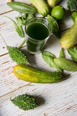 Close up of fresh vegetable juice in a glass along with food ingredients.