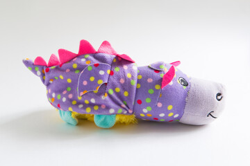 Plush soft children's toy purple dragon with colorful round spots. Turn it inside out. White...