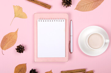 Autumn background with coffee, cinnamon and leaves on light background