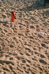 Red lifeguard inventory on a sandy and pebble beach.