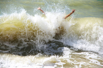 Young woman having fun in stormy sea