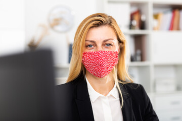 Portrait of businesswoman in protective face mask in business office, new normal business process