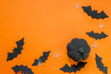 Happy halloween holiday. Halloween decorations, black and white pumpkins, bats, ghosts on a black...