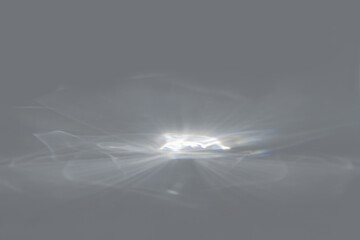 Blurred overlay effect for photo and product mockups presentation. Empty scene with gray background and organic drop shadows and rays of light. Natural rainbow light refraction caustic effect. 
