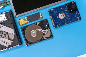 Parts of a modern computer. The insides of a laptop on a blue background, flat lay composition
