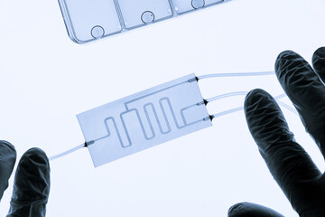 Organ on chip OOC and lab on chip LOC - microfluidic device chip that simulates biological organs and laboratory device . Prototype of design lab-on-a-chip LOC in microfluidic laboratory