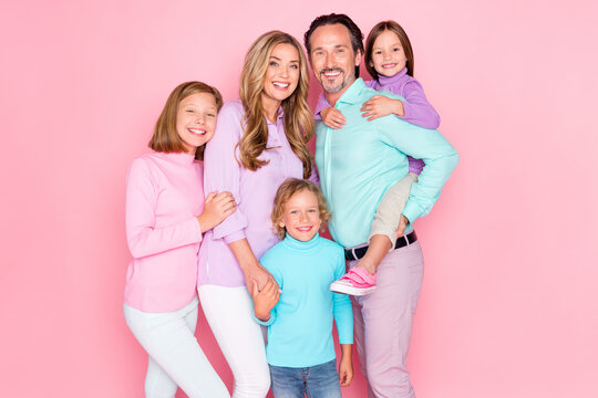 Photo of dream big family enjoy spend weekend together positive daddy hug his younger daughter piggyback mommy toothy smile with two other kids isolated over pastel color background