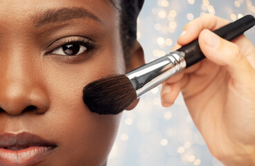 beauty, cosmetics and people concept - close up of face of beautiful young african american woman...