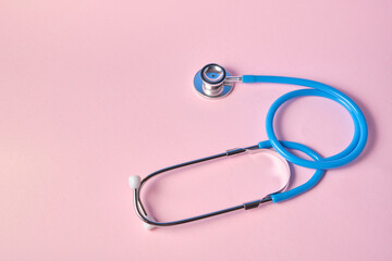blue stethoscope on pink background. For check heart or health check up concept