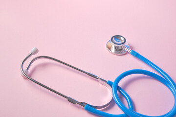 blue stethoscope on pink background. For check heart or health check up concept