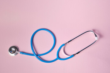 blue stethoscope on pink background. For check heart or health check up concept